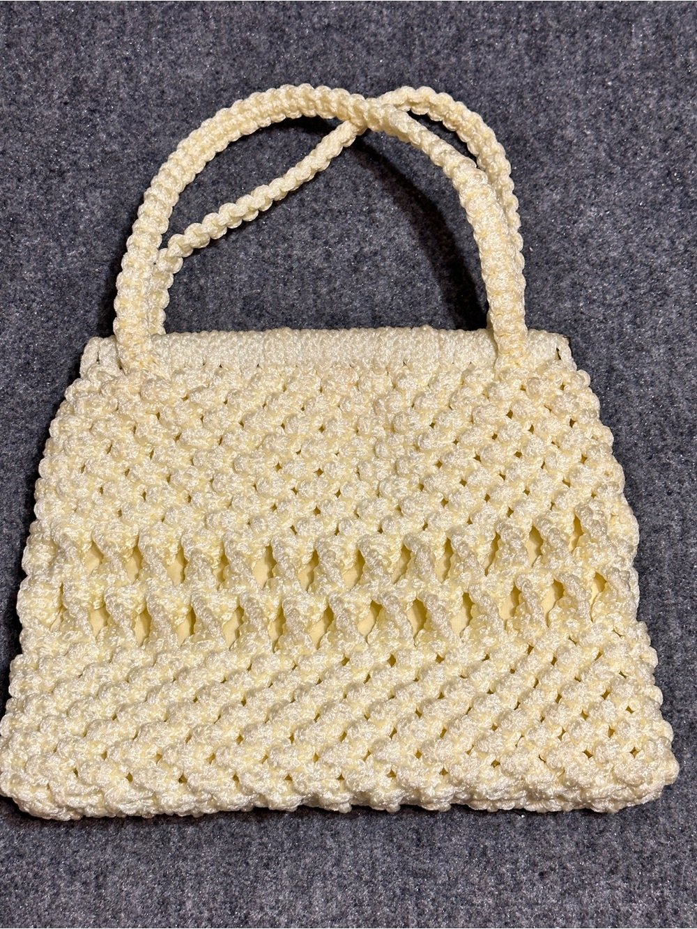 Cream-colored, hand-knotted macramé handbag